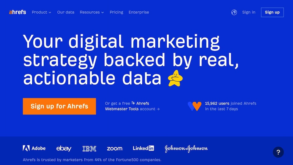 Blue webpage with text: "Your digital marketing strategy backed by real, actionable data." Buttons: "Sign up for Ahrefs." Logos: Adobe, eBay, IBM, Zoom, LinkedIn, Johnson & Johnson.