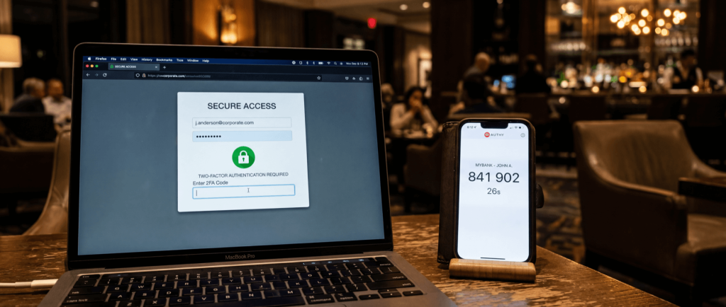 Laptop displaying secure access login page with two-factor authentication prompt, next to a smartphone showing a 2FA code.